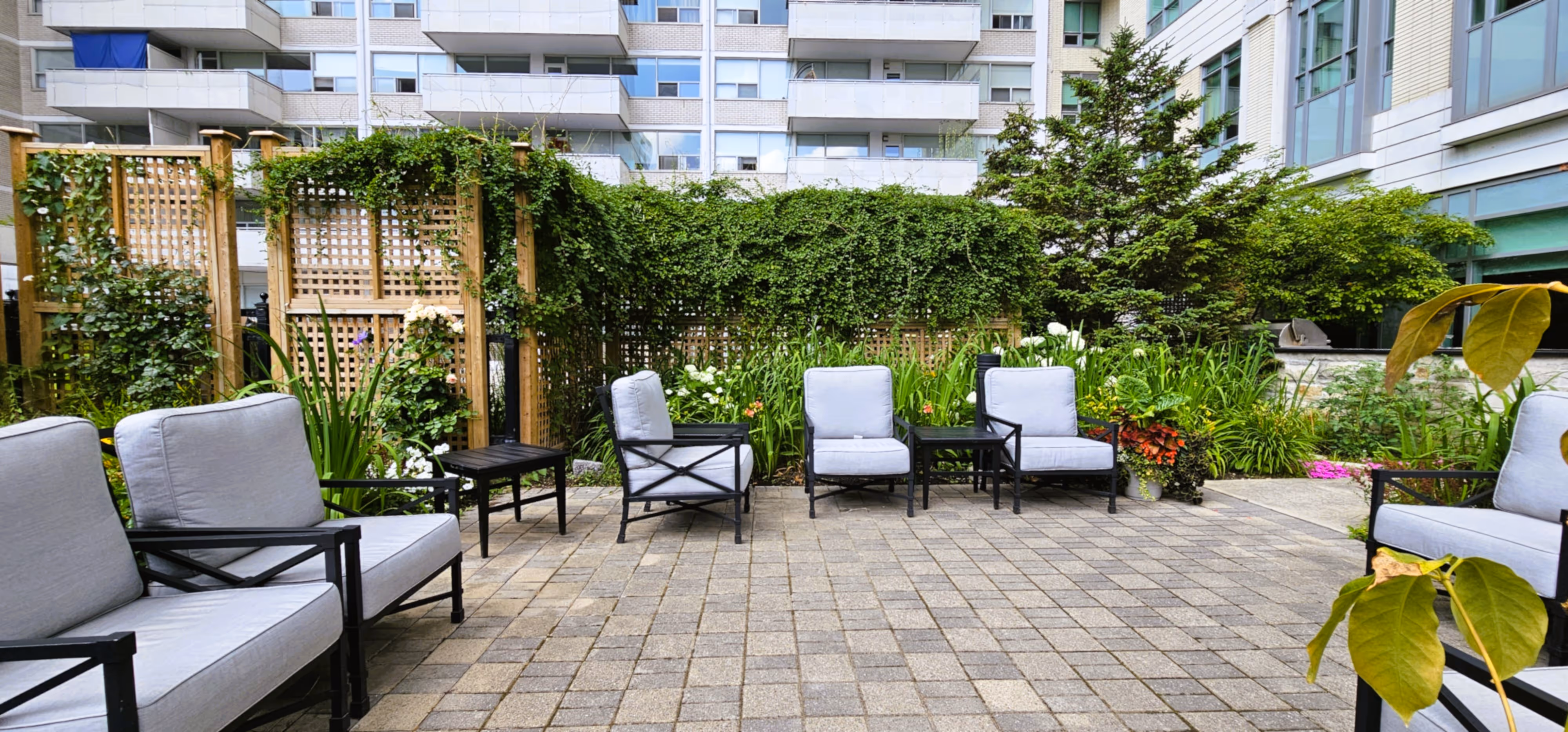 Outdoor seating area with stone pavers and lawn chairs