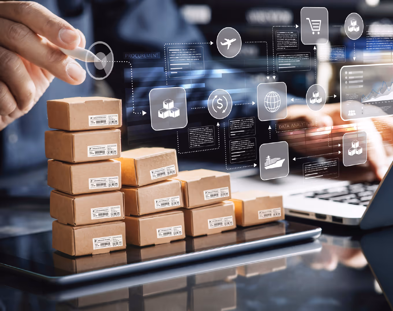 Stacked cardboard shipping boxes on a digital tablet with a person using a laptop and virtual logistics and procurement icons overlay.