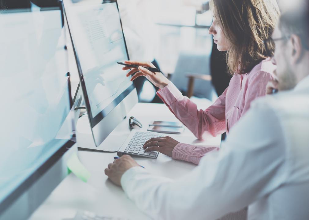 people pointing at computer