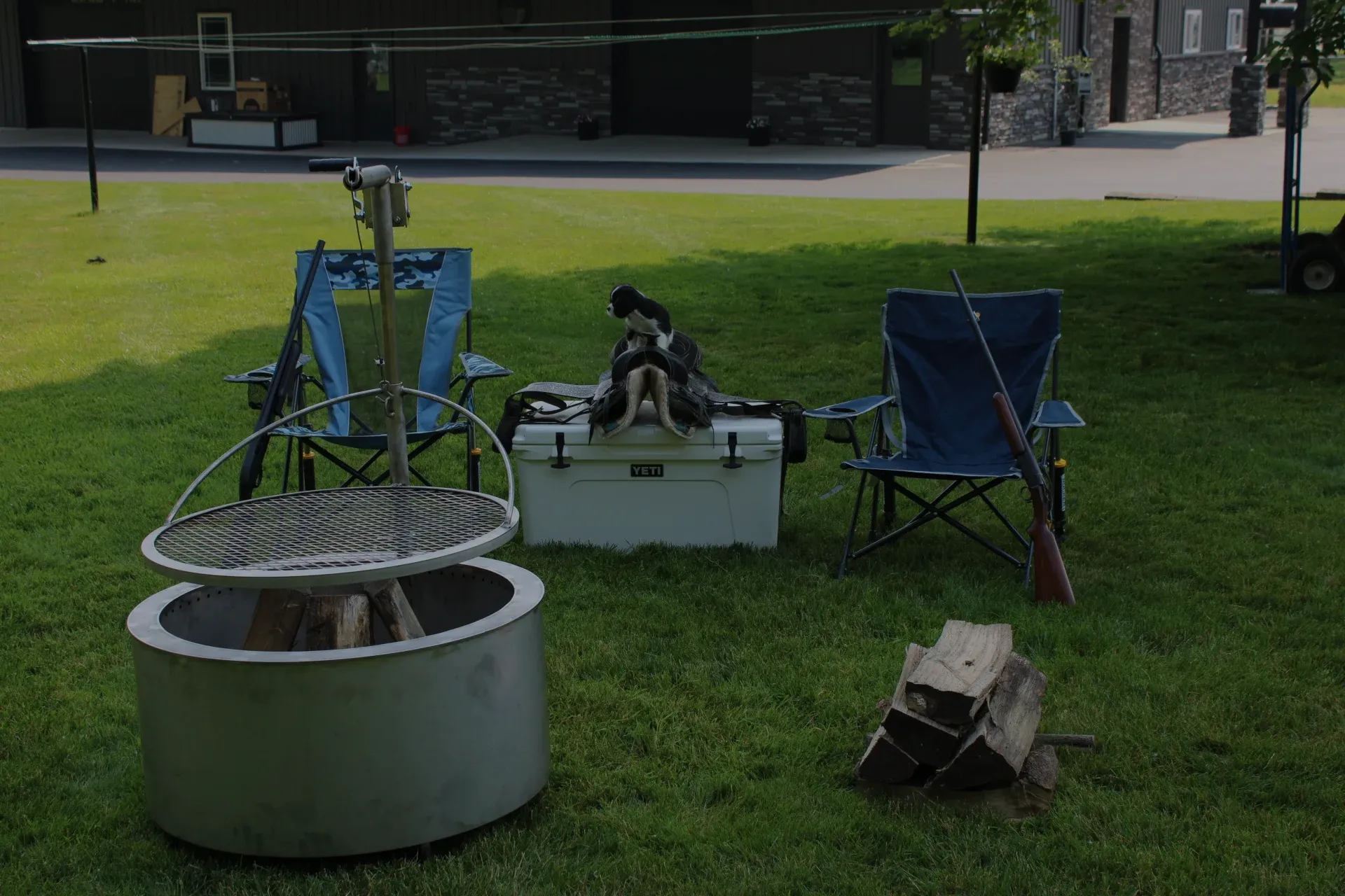 bbq grill with camping chair and cooling in background