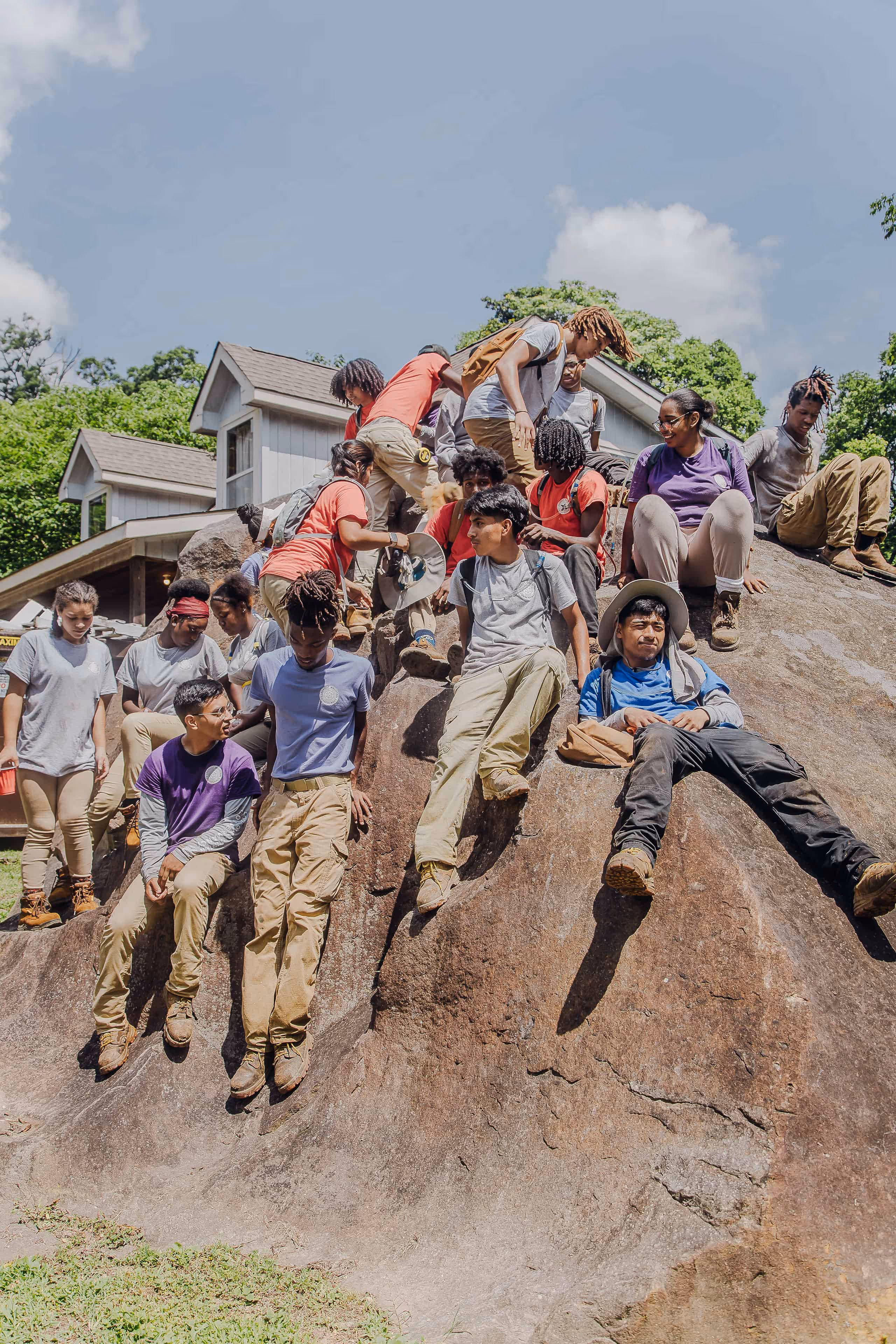 Lookout Mountain Conservancy interns from Howard High School climbing a boulder