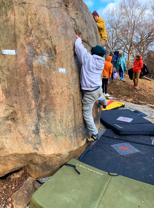 Climbers climb boulders at Boulderfest.