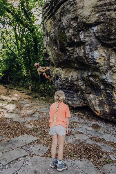 A family rock climbs at the boulder fields at Wahautchie.