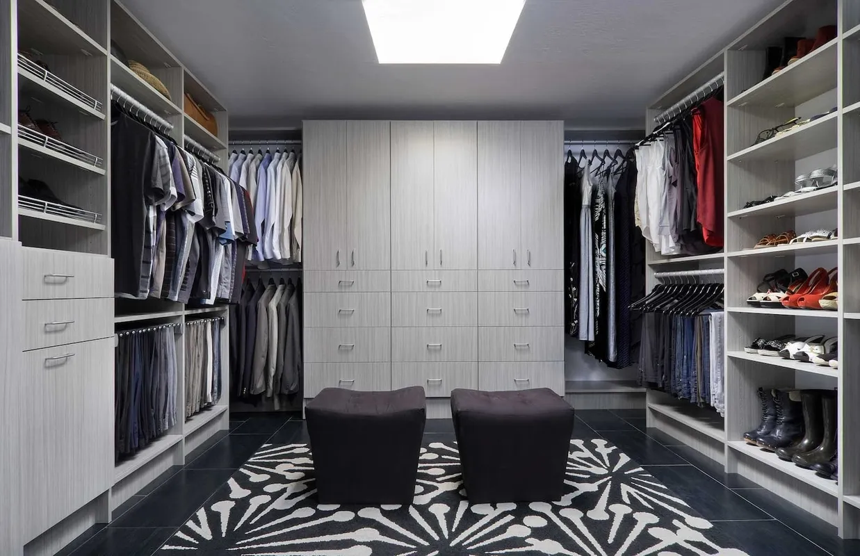 A once wide open closet with no additional storage now complete with full wardrobe, clothes and shoe racks, making use of the vertical space in a tight room.