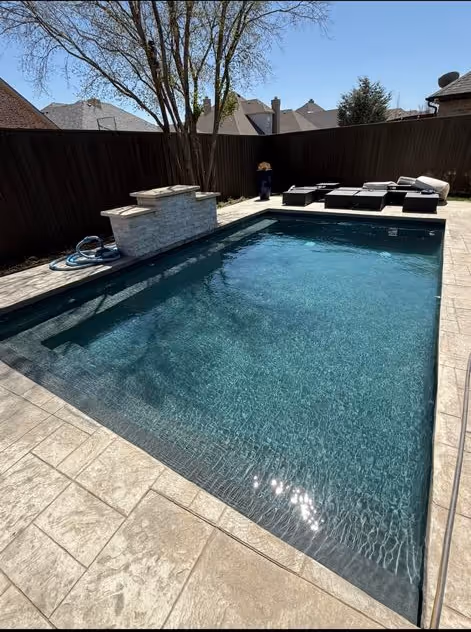 pool with waterfall feature by Lone Star Luxury pools in Amarillo Texas
