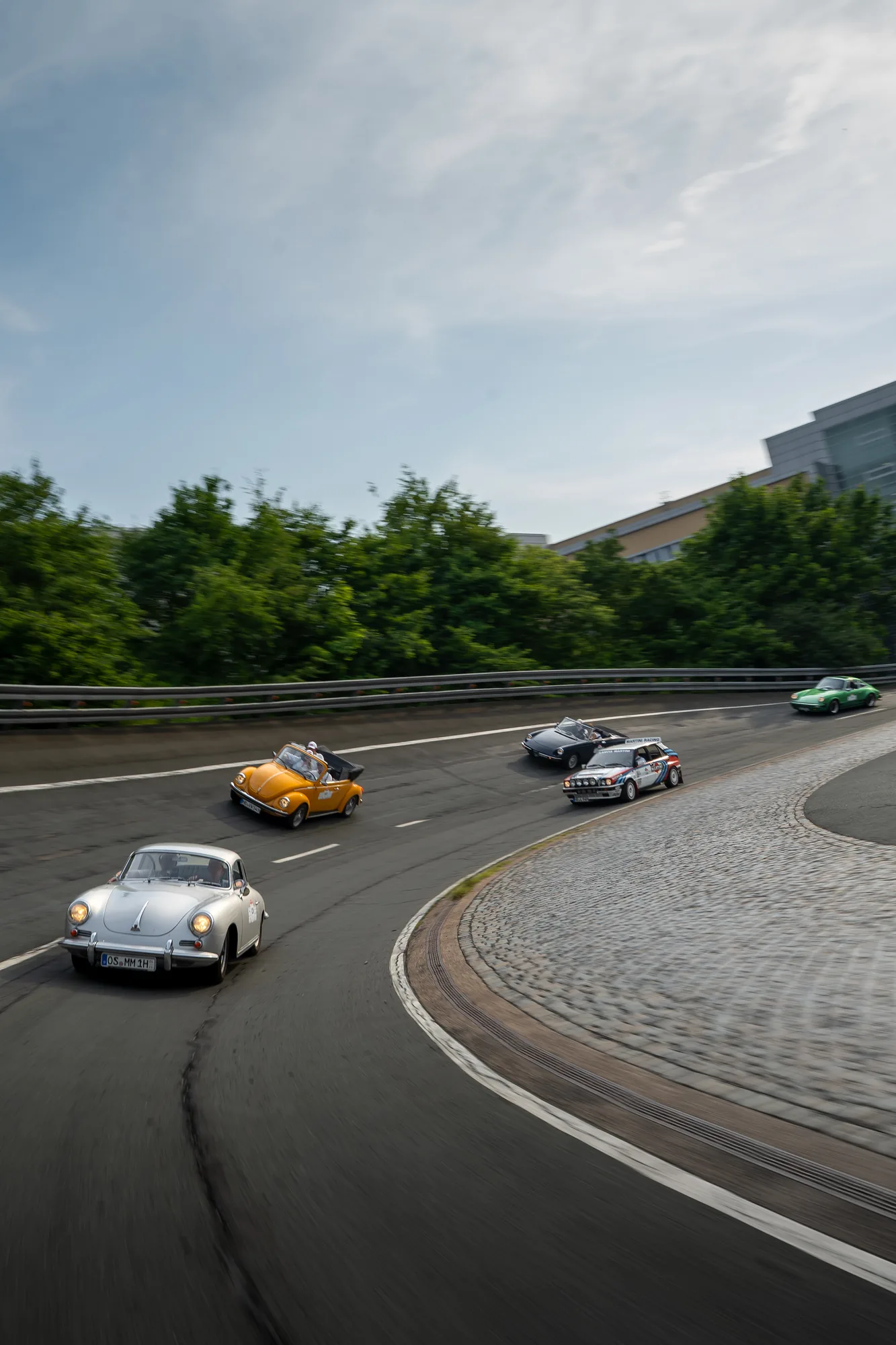 Mehrere Oldtimer bei der Fahrt durch eine Steilkurve bei den BOC 2026.