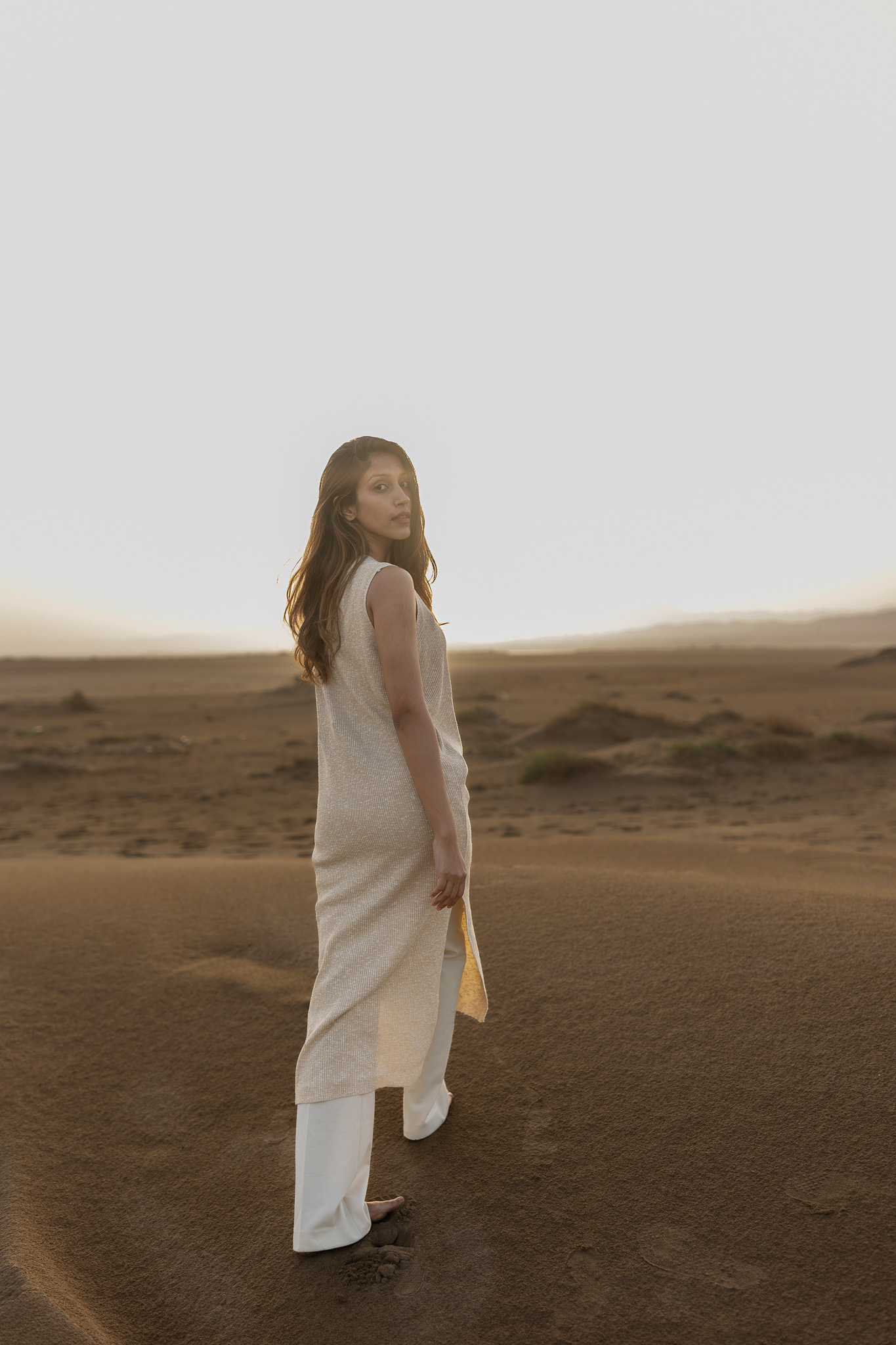 woman walking away in the desert