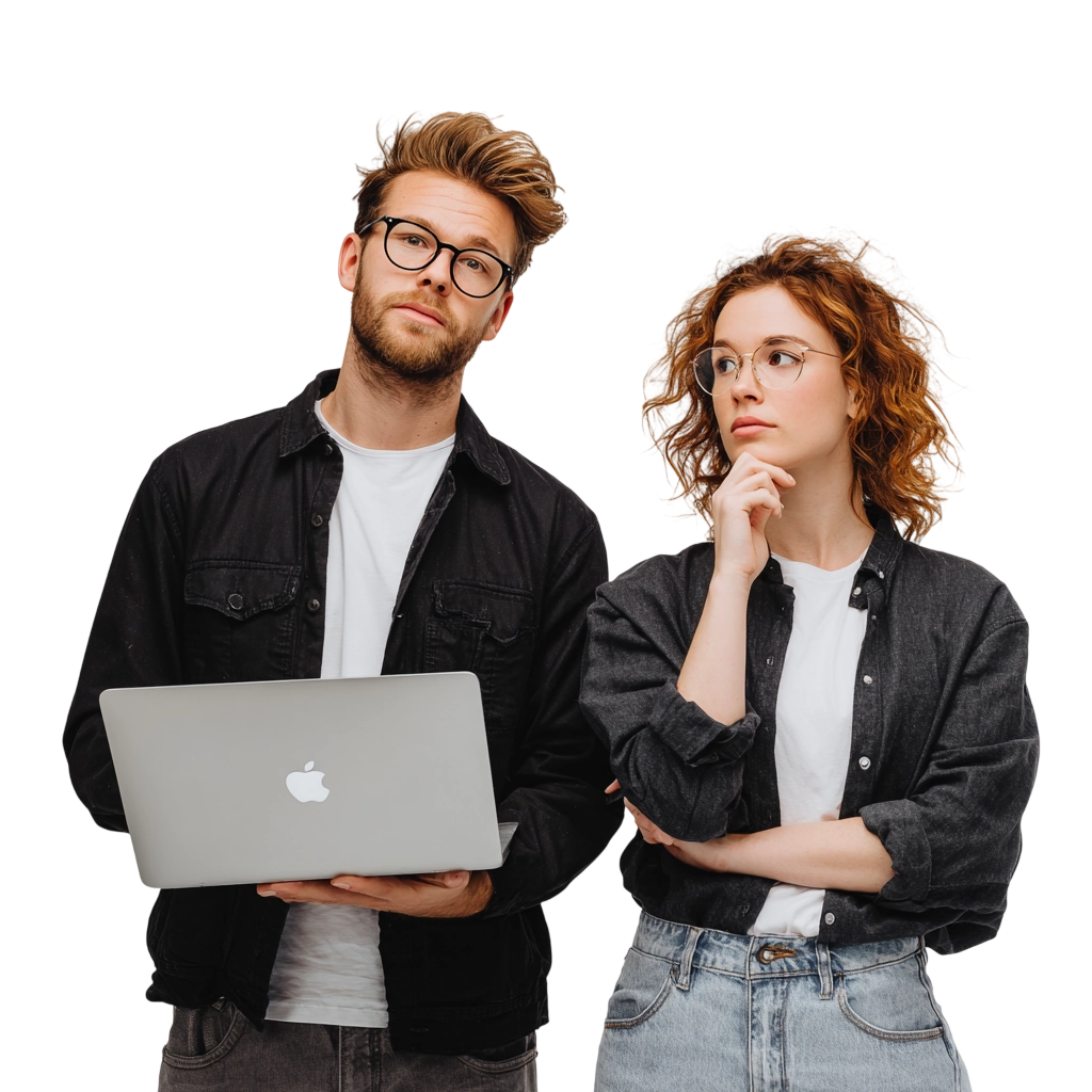 Man with glasses holding a MacBook laptop and a woman with glasses looking thoughtful, both wearing casual dark jackets and white shirts.