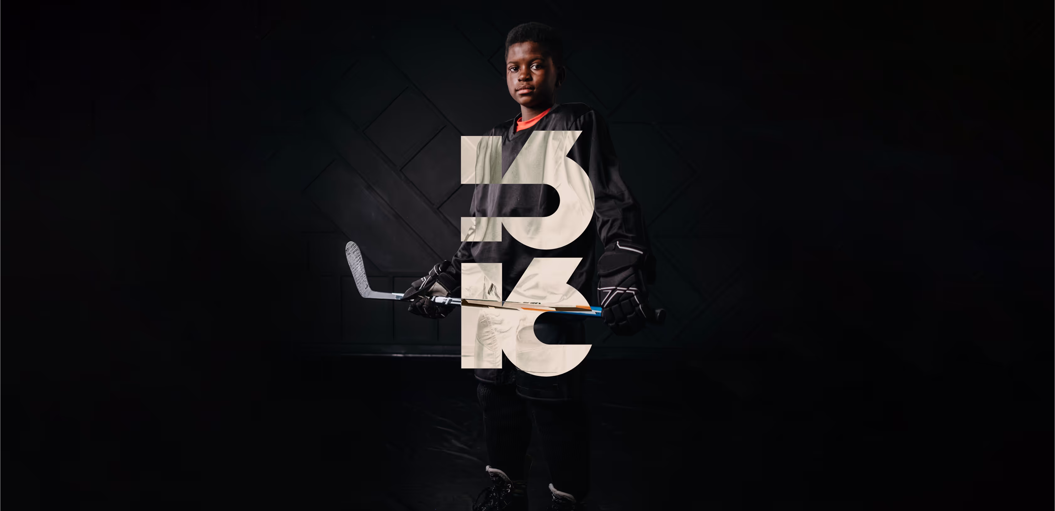 An african american boy in his hockey equipment.