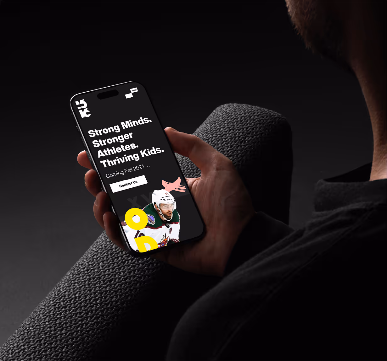 A mockup of a man holding an iPhone and browsing the 1616 website. 