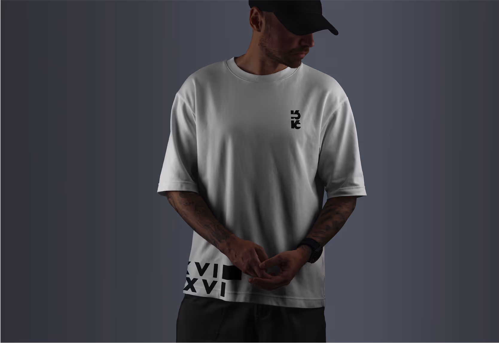 A man wearing an oversized 161 merch t-shirt. 