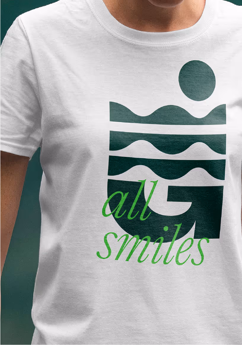 A young woman facing forwads wearing green by bible camp merchandise.