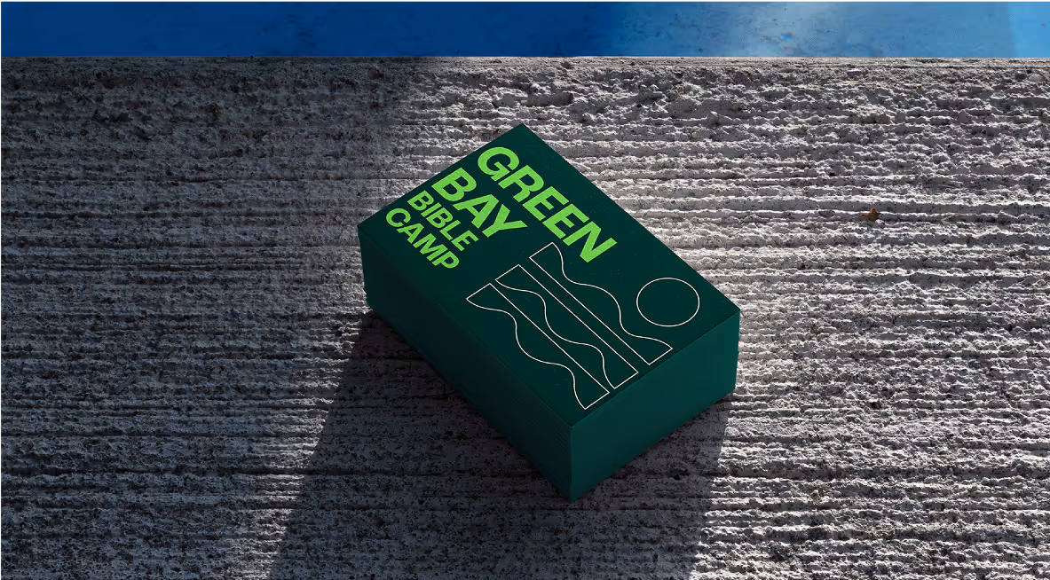 A stack of business cards sitting on a concrete ledge.