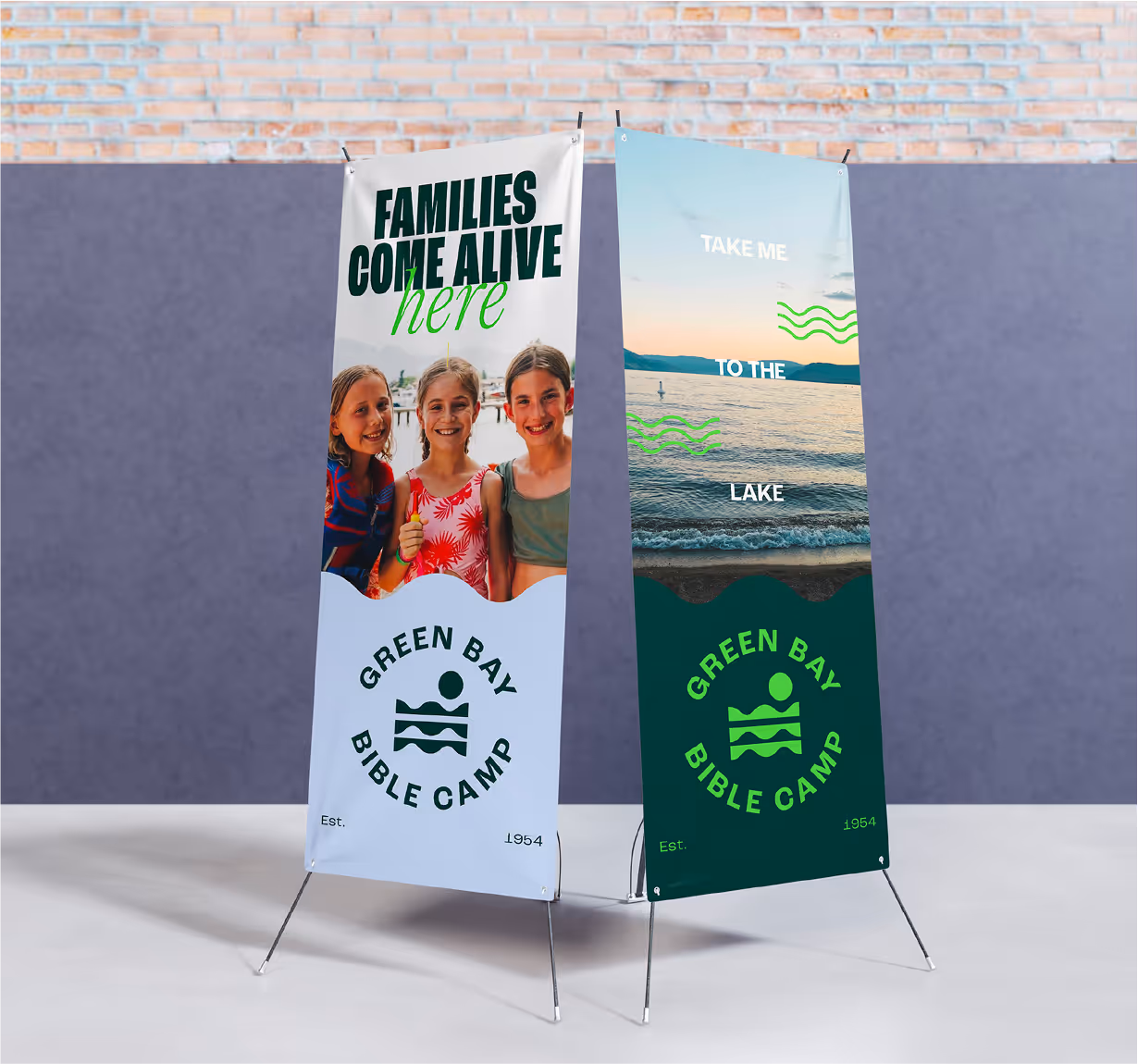 A mockup of two rollup banners with green bay bible camp branding.