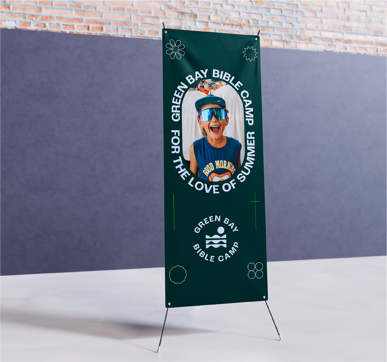 A mockup of a hanging string banner showcasing green bay bible camp branding.