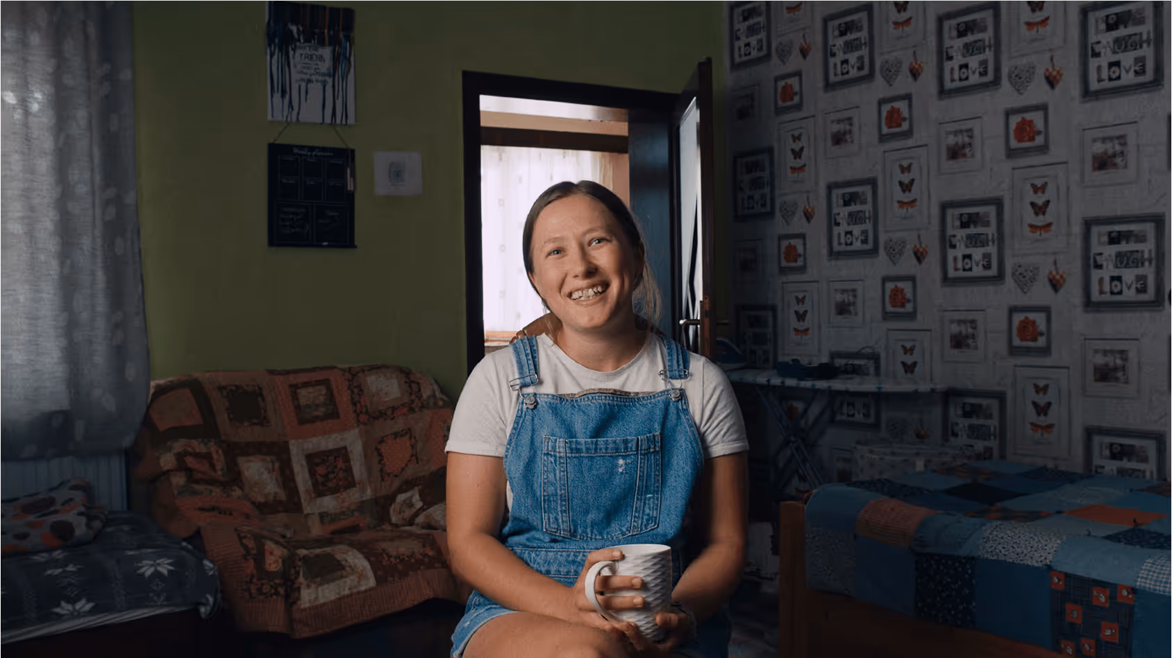 A straight on portrait image of a young Romanian lady smiling at the camera.
