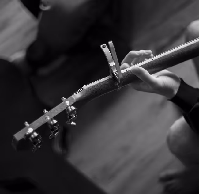 hands playing a guitar