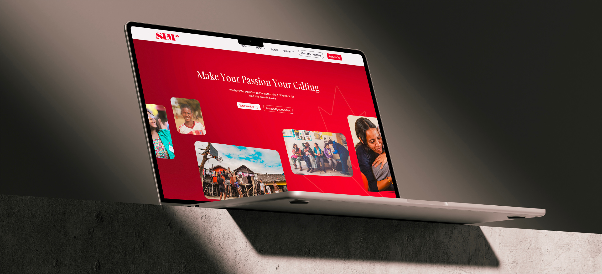 An image of a Macbook sitting on a ledge showcasing the SIM website.