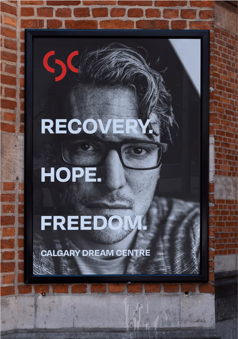 Black and white poster of a man wearing glasses with text: Recovery. Hope. Freedom. Calgary Dream Centre.
