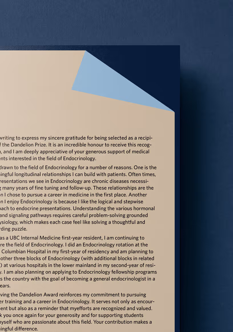 Partial view of a beige paper with typed text, top right corner partially folded revealing a blue underside, placed on a dark blue textured background.