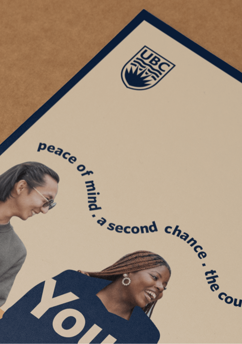 Partial view of a UBC promotional poster featuring two smiling young people and the text 'peace of mind, a second chance.'