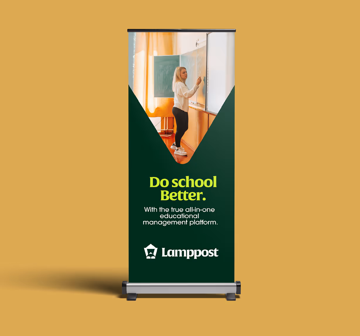 Roll-up banner featuring a woman writing on a classroom whiteboard with text promoting Lamppost, an all-in-one educational management platform.