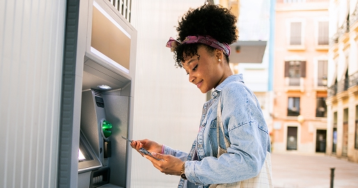 woman putting her card into an ATM
