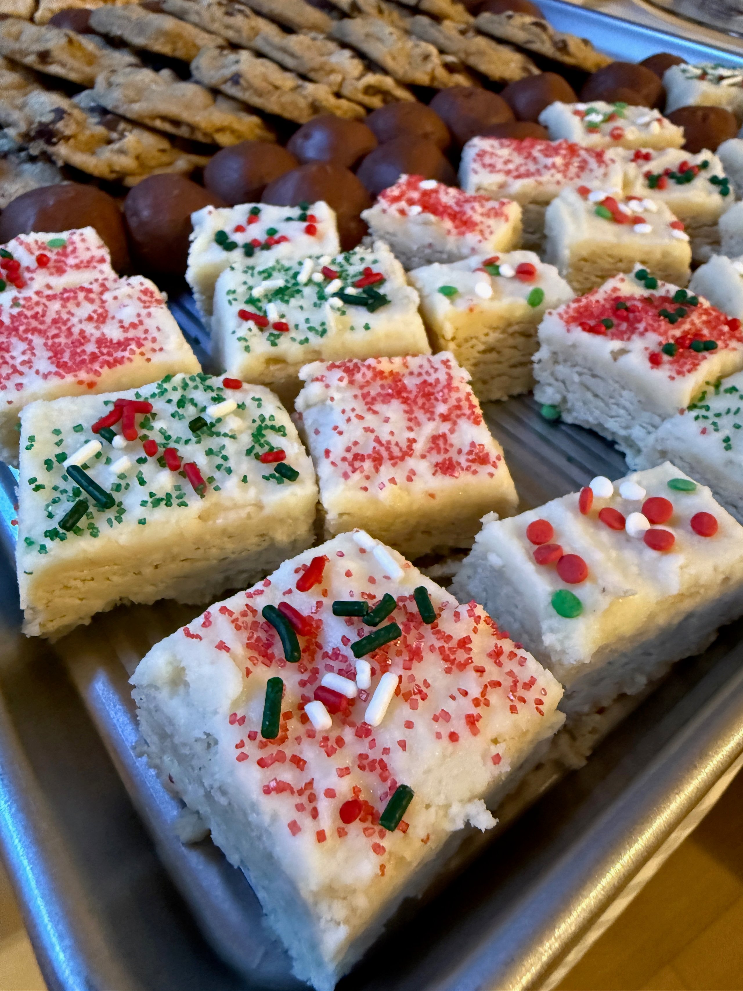 Holiday sugar cookies with red and green sprinkles on baking sheet