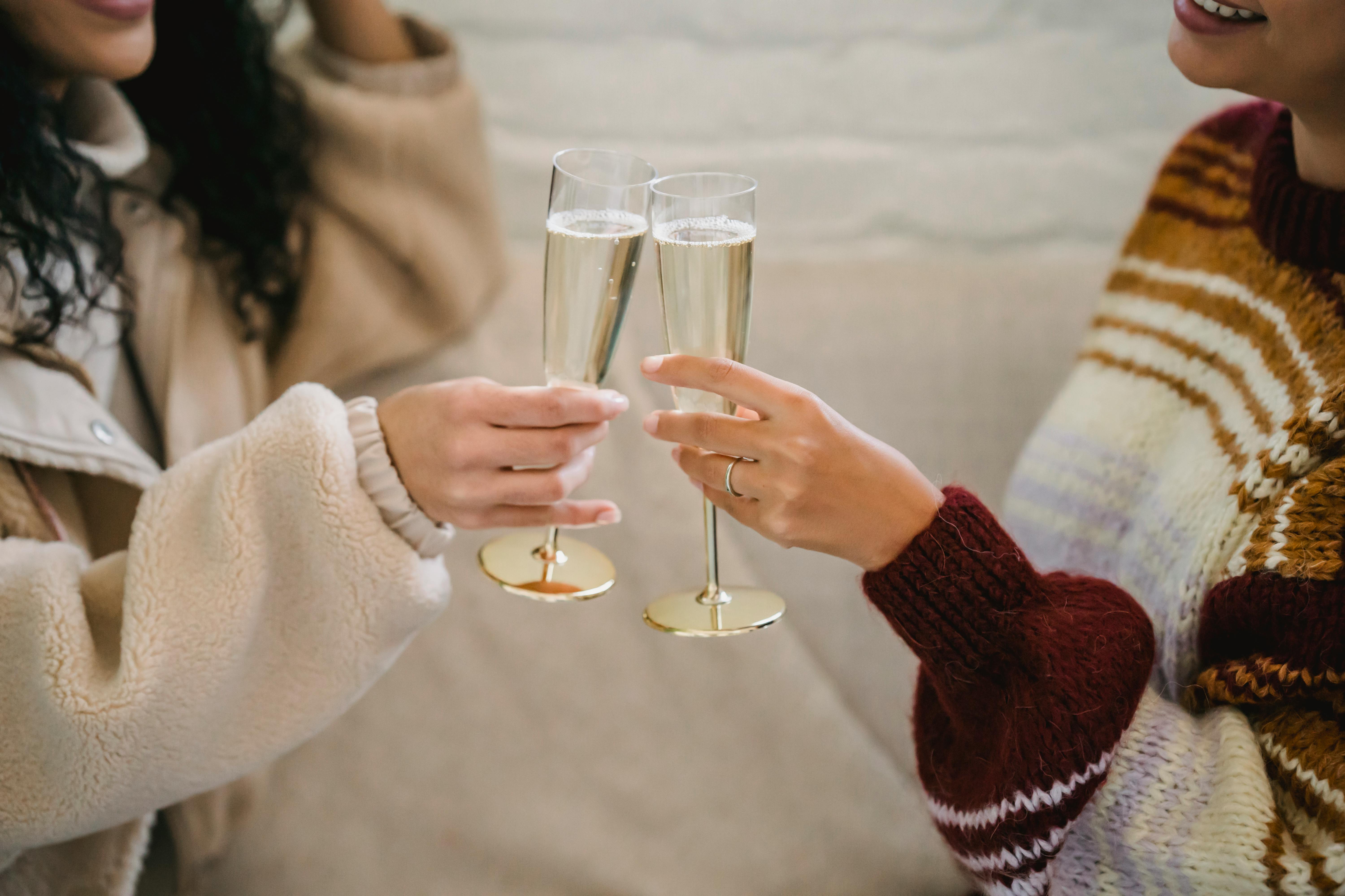 Tasty champagne toast with wandering friends in cozy winter sweaters
