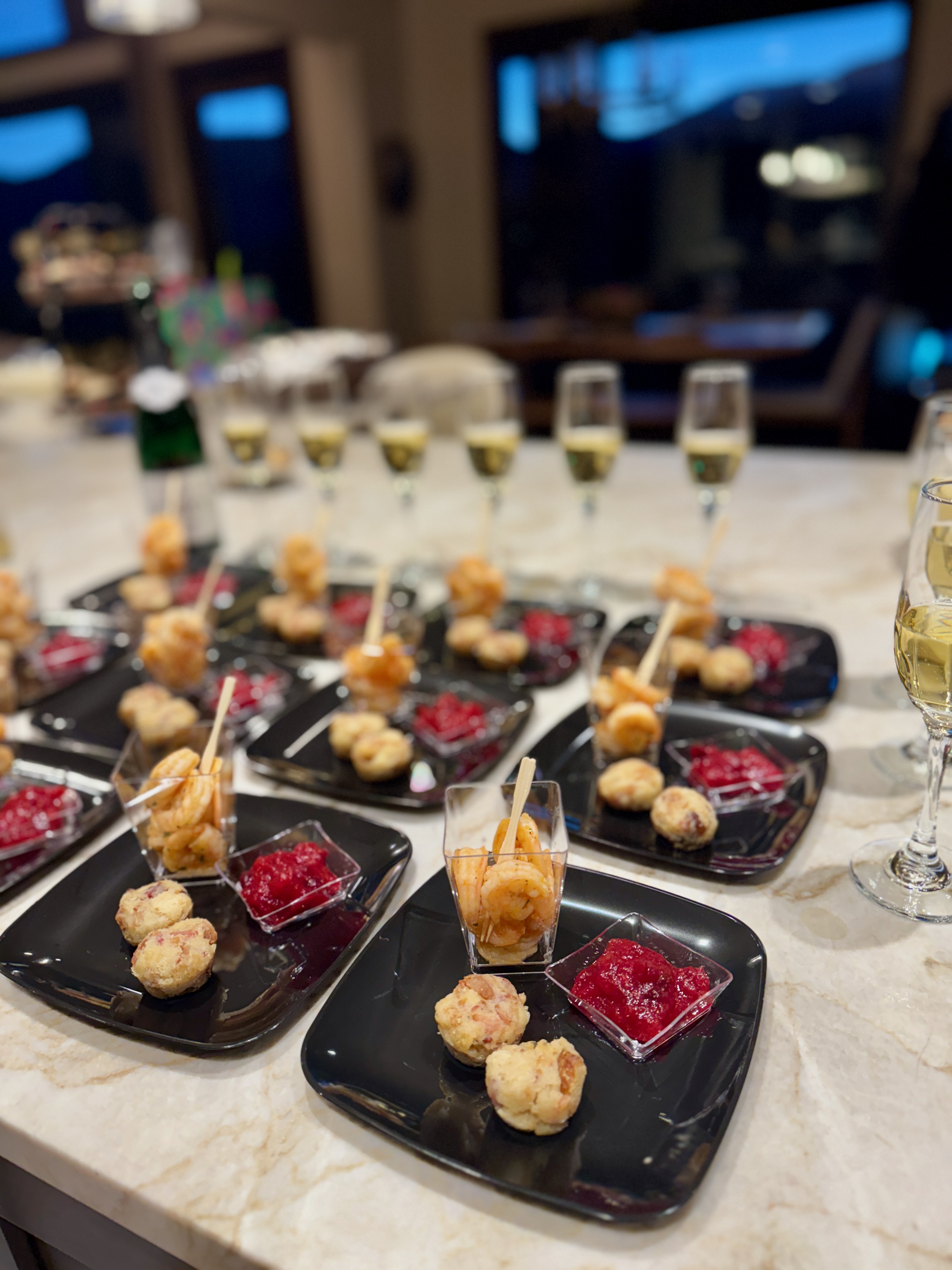 Tasty wandering appetizers with red sauce and champagne glasses