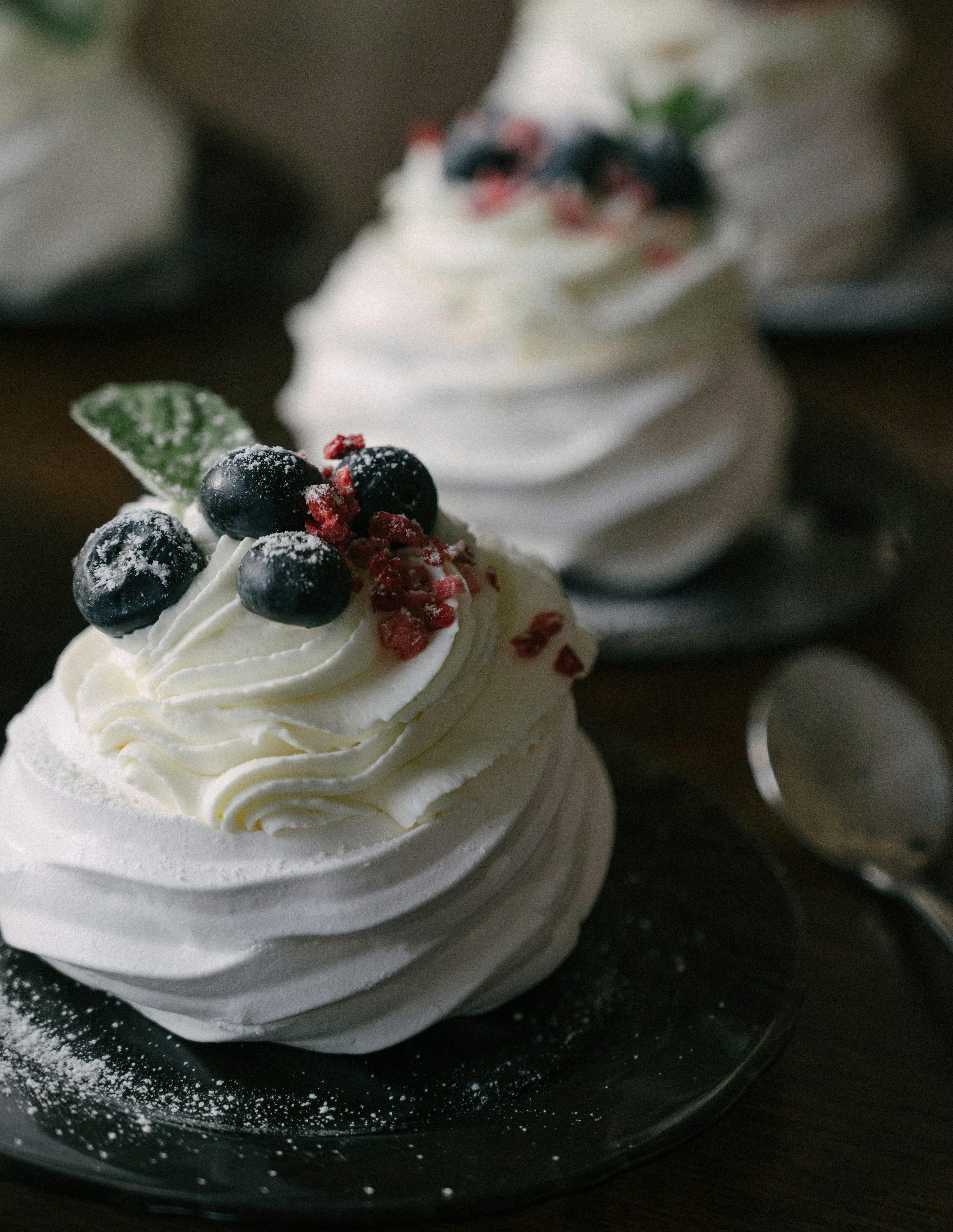 Tasty wandering pavlova with blueberries and raspberry crumbles
