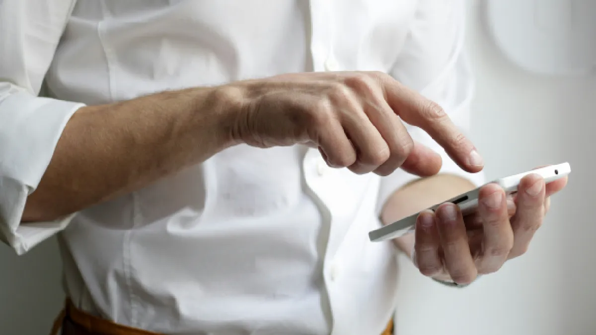 Person using a smartphone, representing what a wellbeing app can and cannot do for mental health