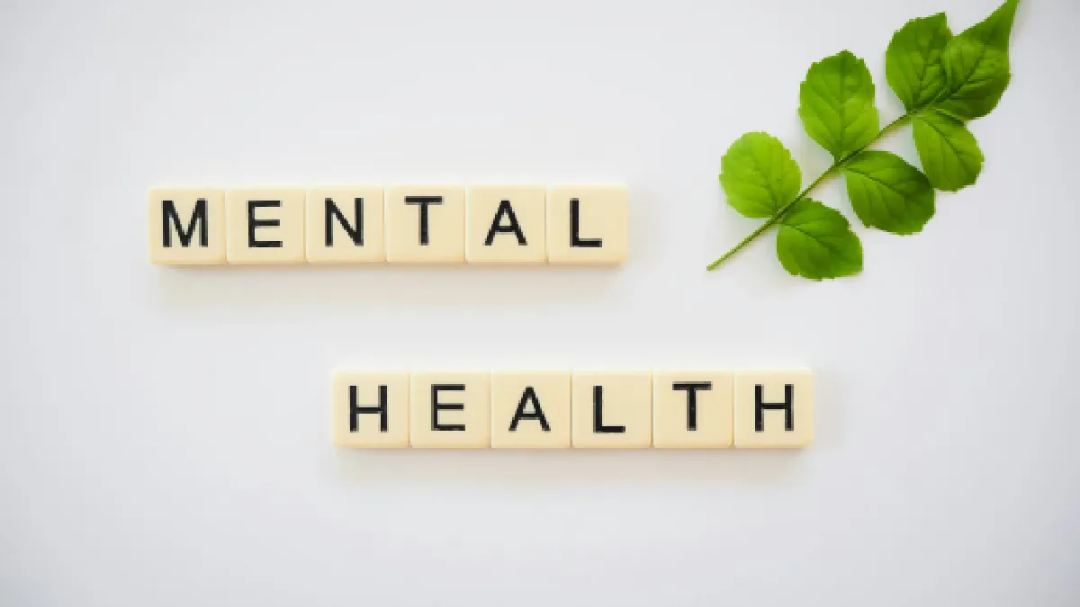 Mental health spelled out in letter tiles, showing why workplace awareness alone is no longer enough