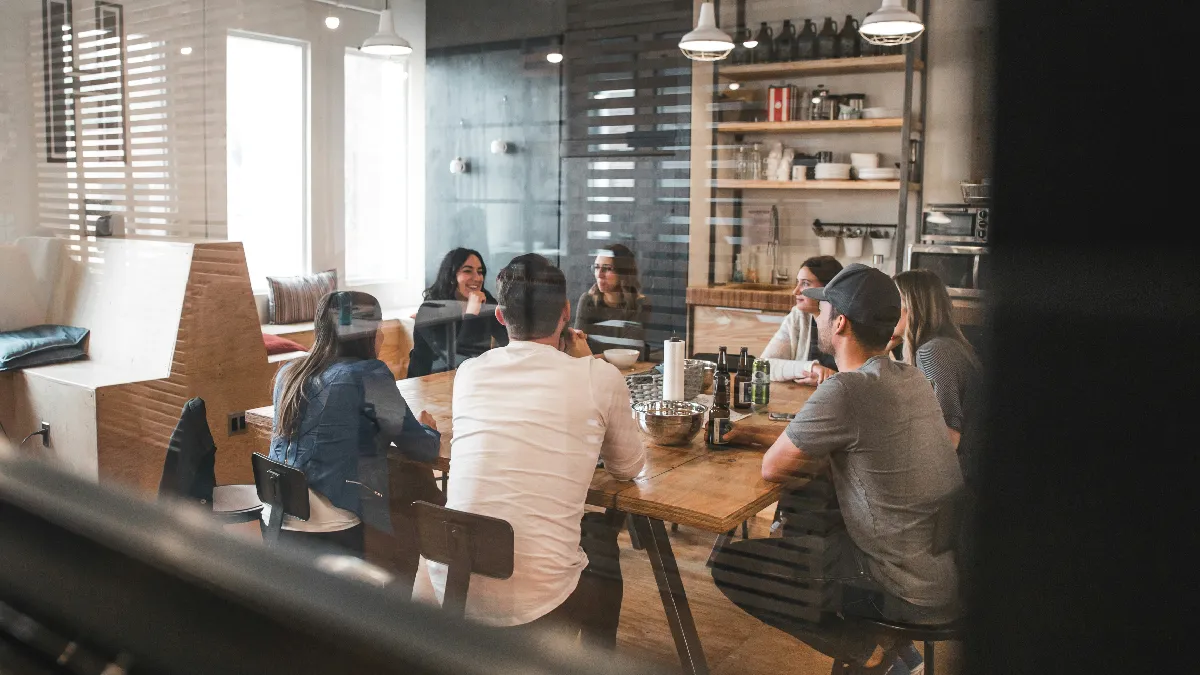 Employees meeting to discuss closing the prevention gap in workplace mental health spending
