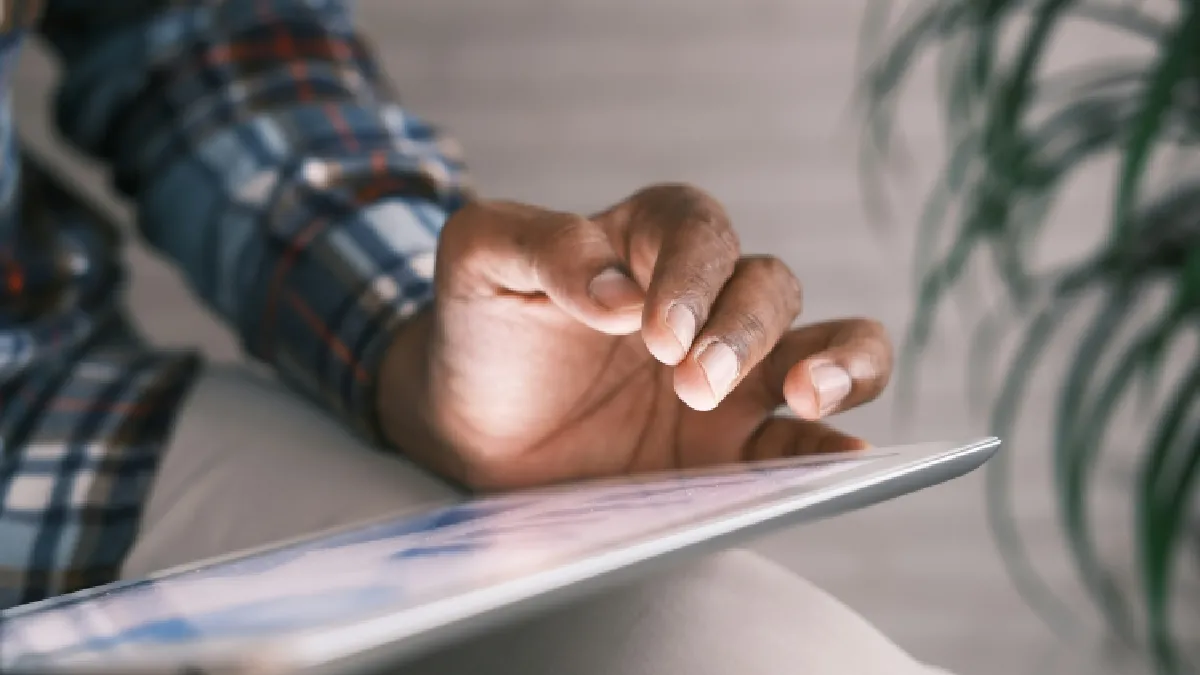 Employee using a tablet to access the Champion Health digital employee benefits hub