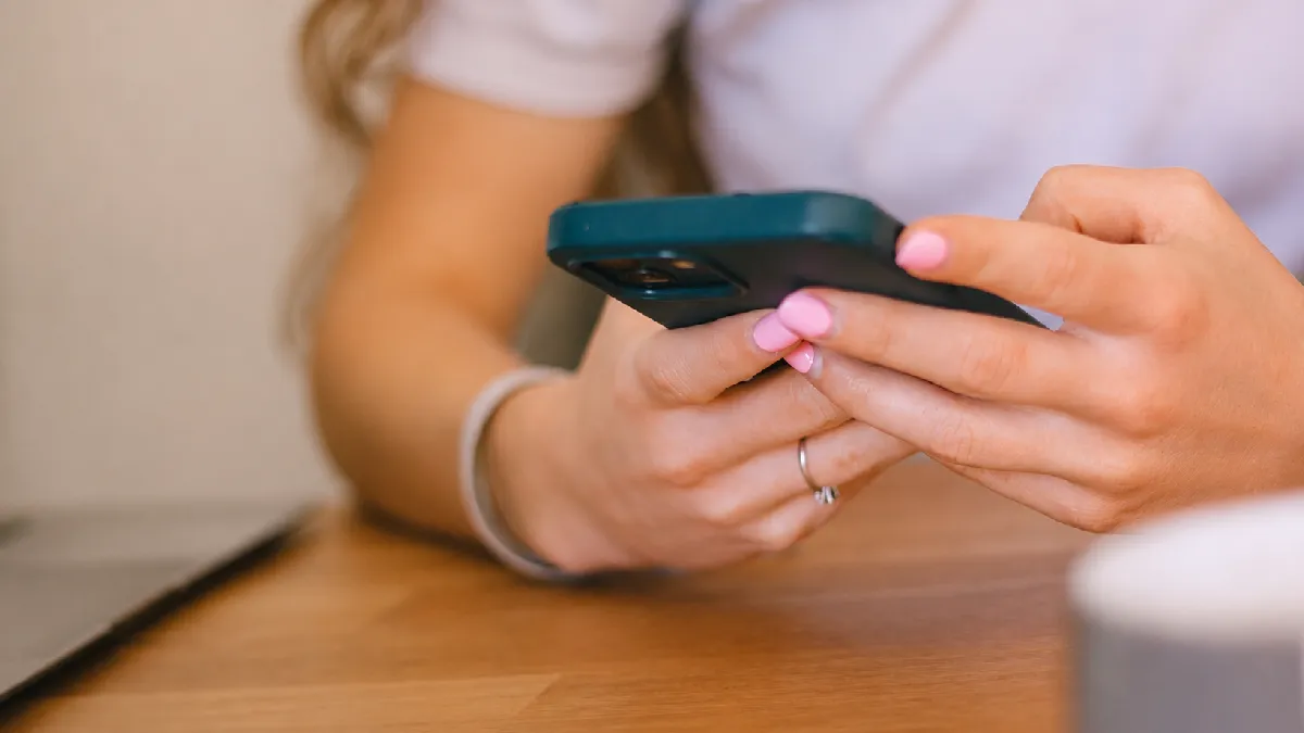 Person using a smartphone, representing the best wellbeing apps available in the UK