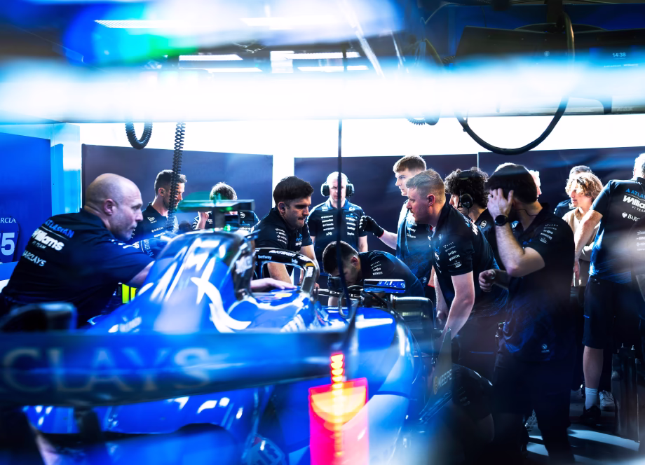 Williams Racing engineers and mechanics working on the F1 car in the garage during a race weekend.