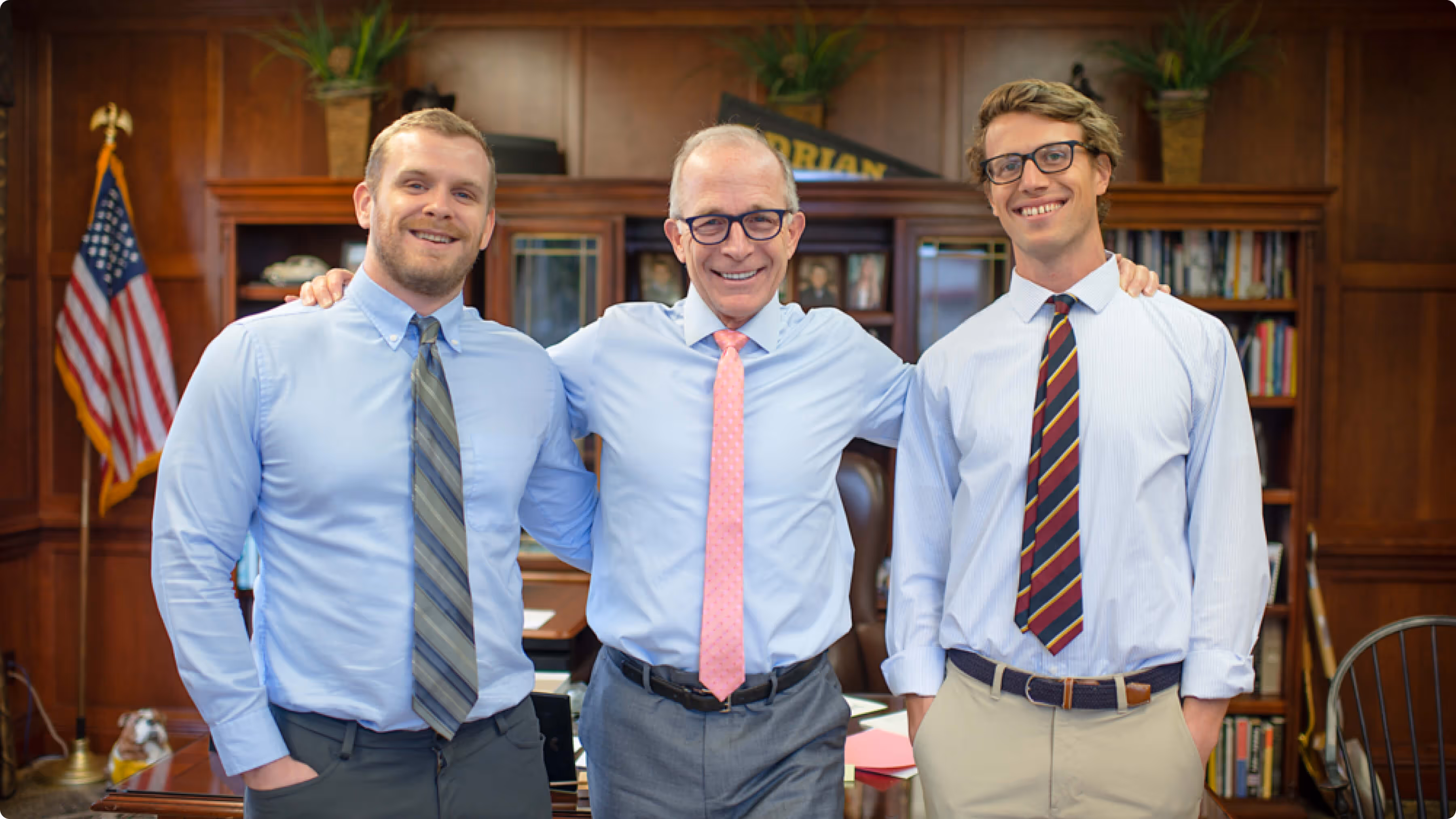 A group of three men standing next to each other.