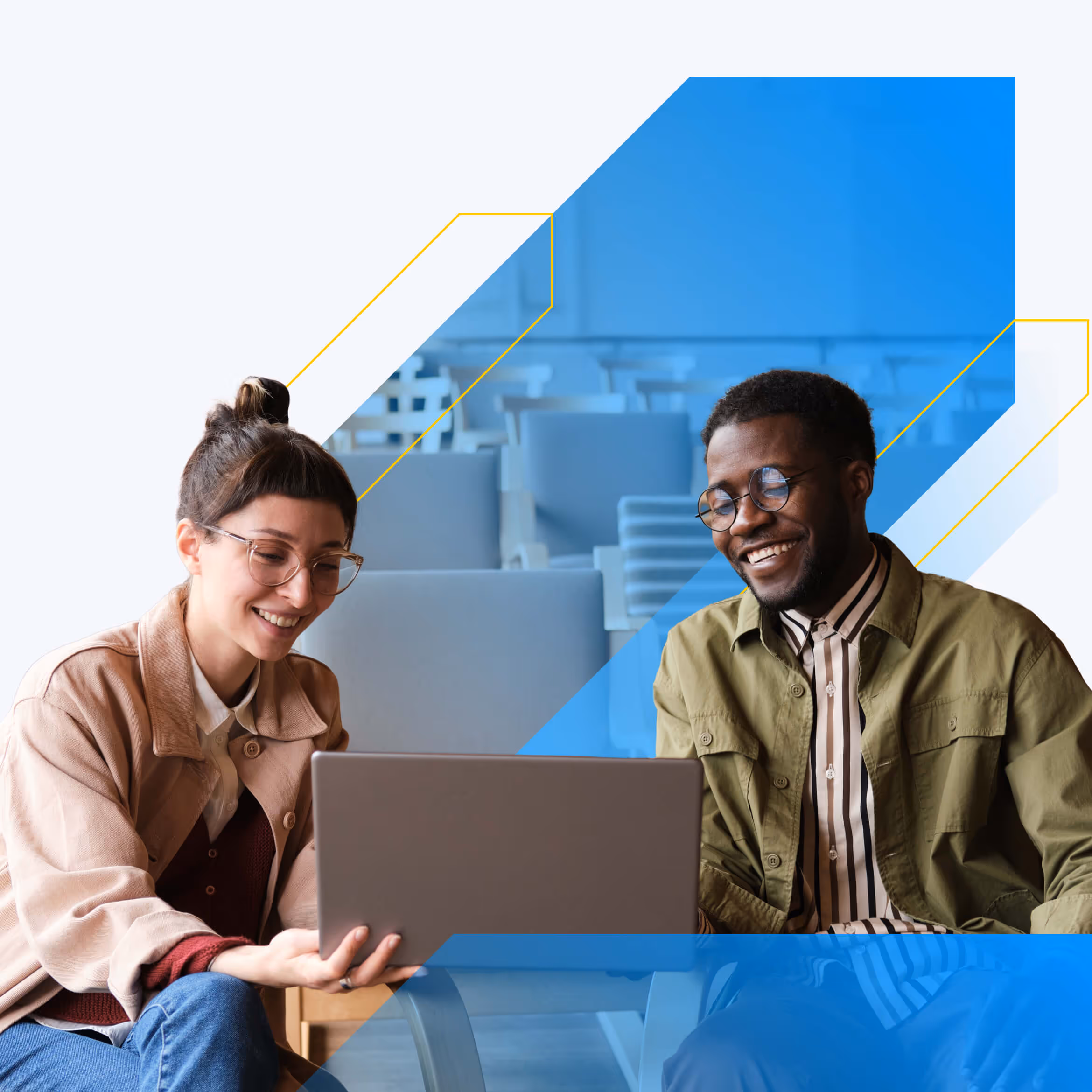 Two students collaborating together at a laptop.