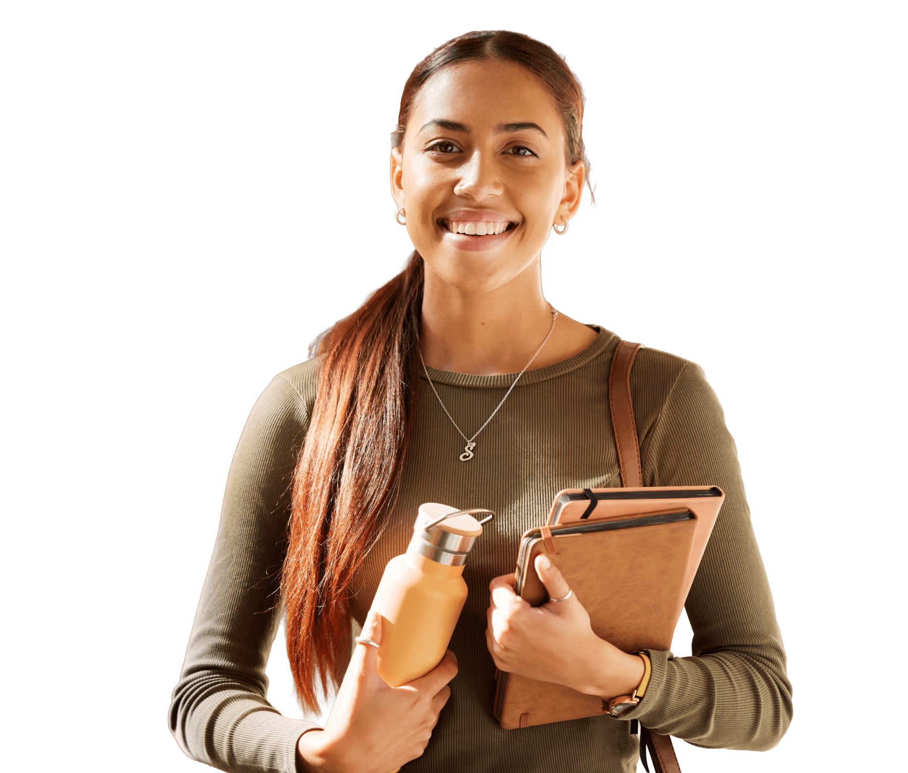A smiling student holding a water bottle and school folders.