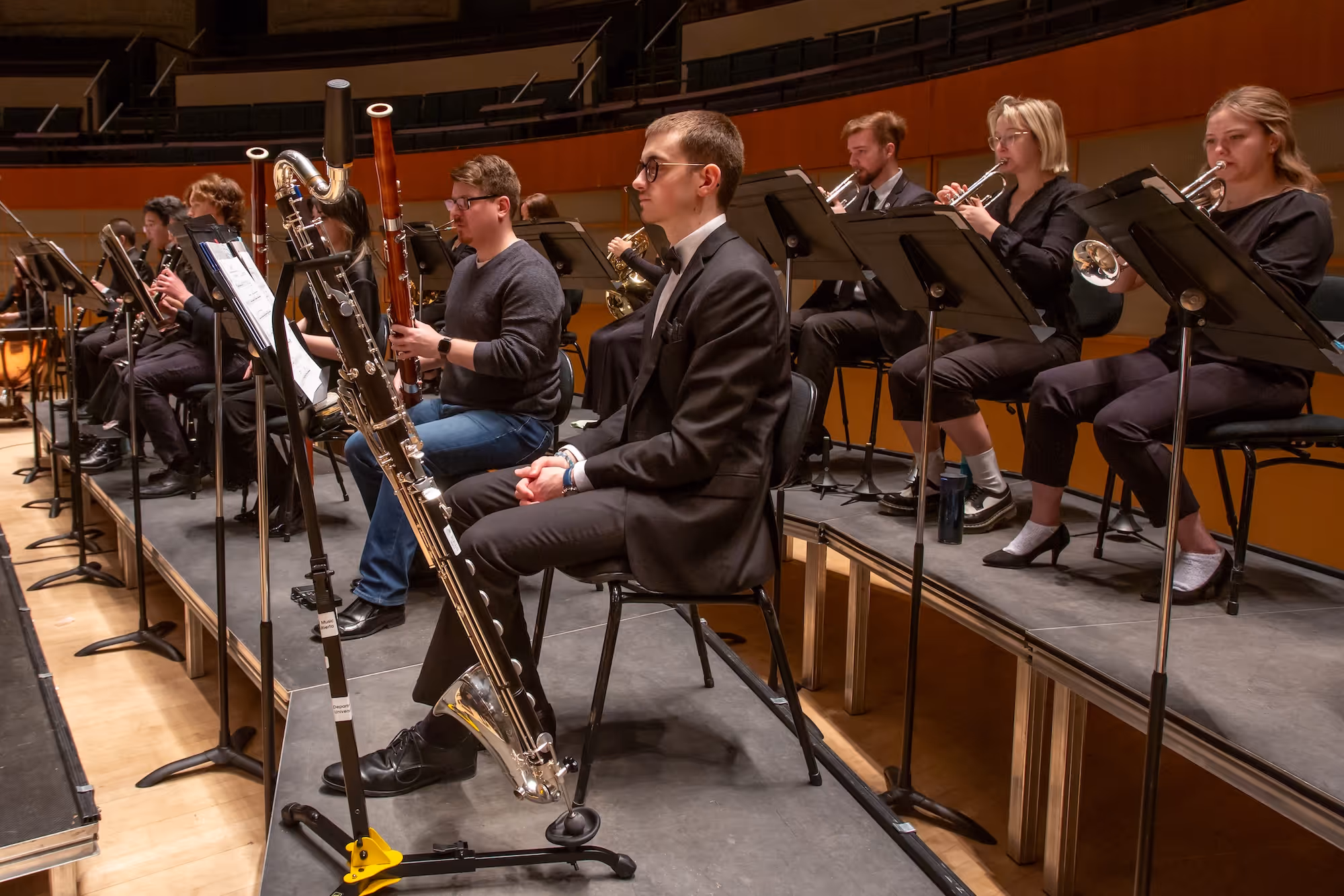 A group of teens playing in the orchestra