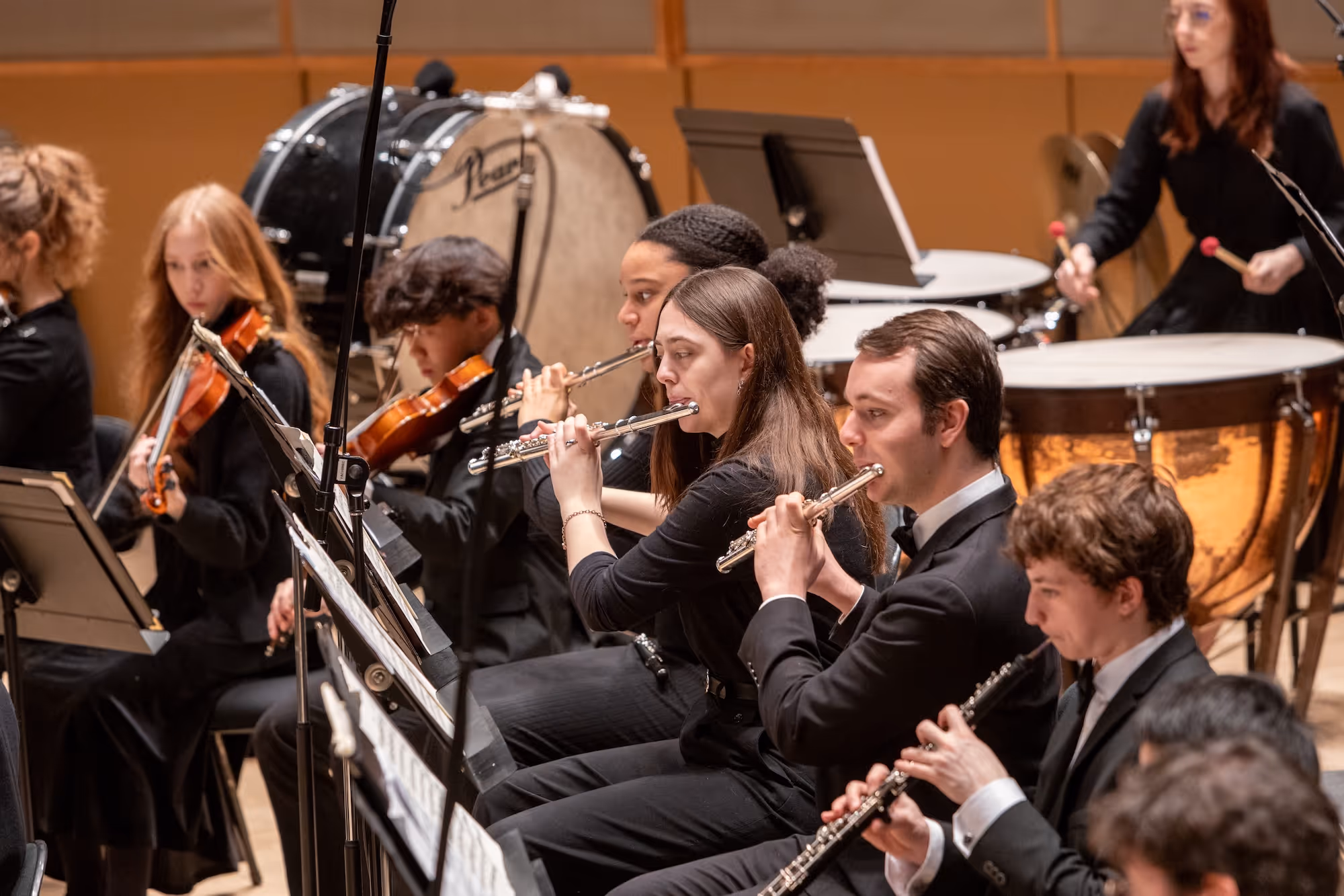 A group of teens playing in the orchestra