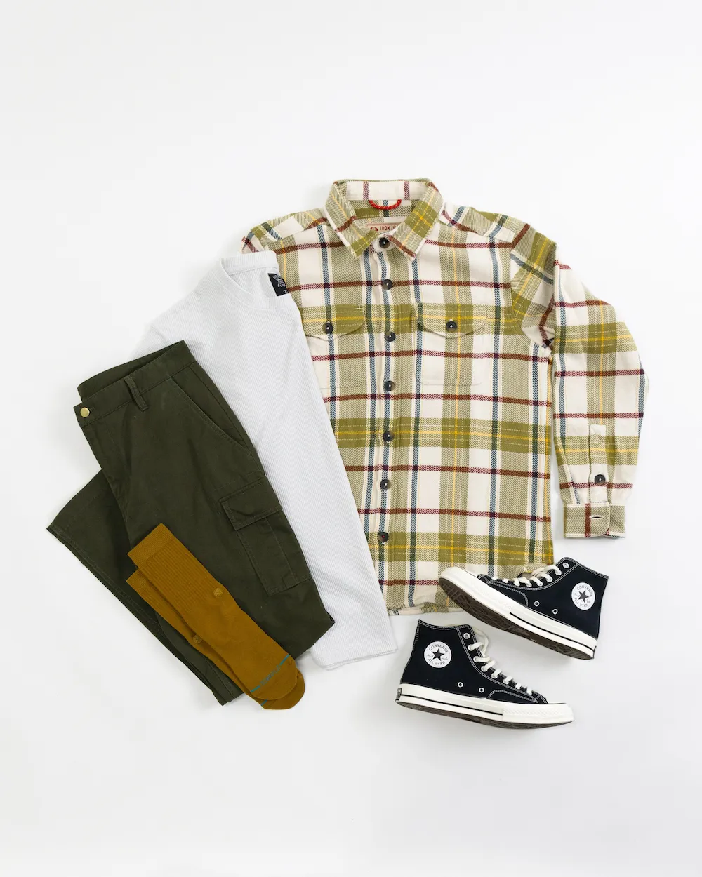 A flannel shirt, a thermal shirt, a pair of chinos, a pair of socks, and a pair of high-top sneakers