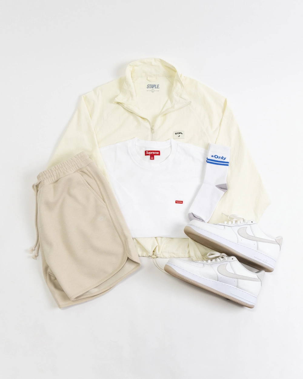 A streetwear jacket, shirt, shorts, socks, and a pair of low-top sneakers.