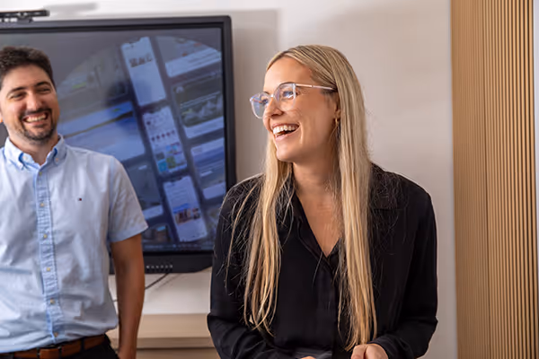 Willow and Chris from the Kook smiling whilst in a team meeting