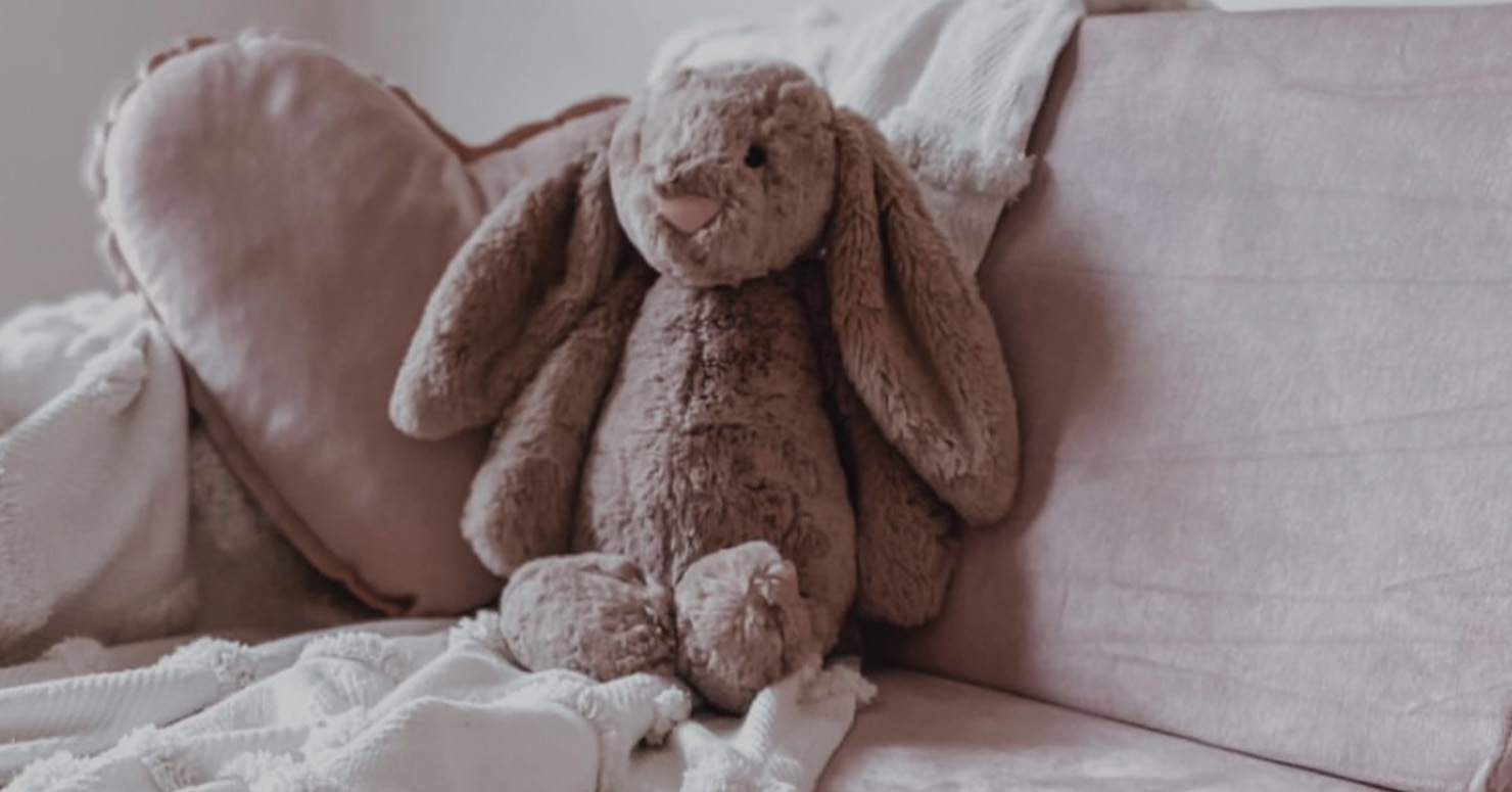 small bunny teddy sitting on couch