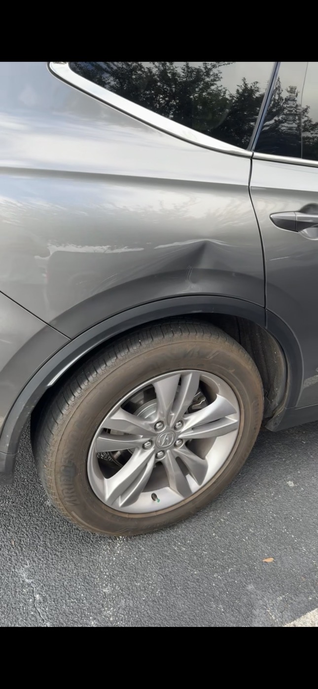 Car panel with a visible dent before paintless dent repair by Georgia Dent Masters