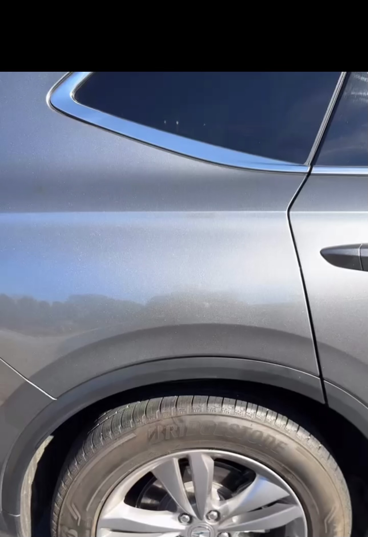 Same car panel restored to a smooth, dent-free finish after paintless dent repair