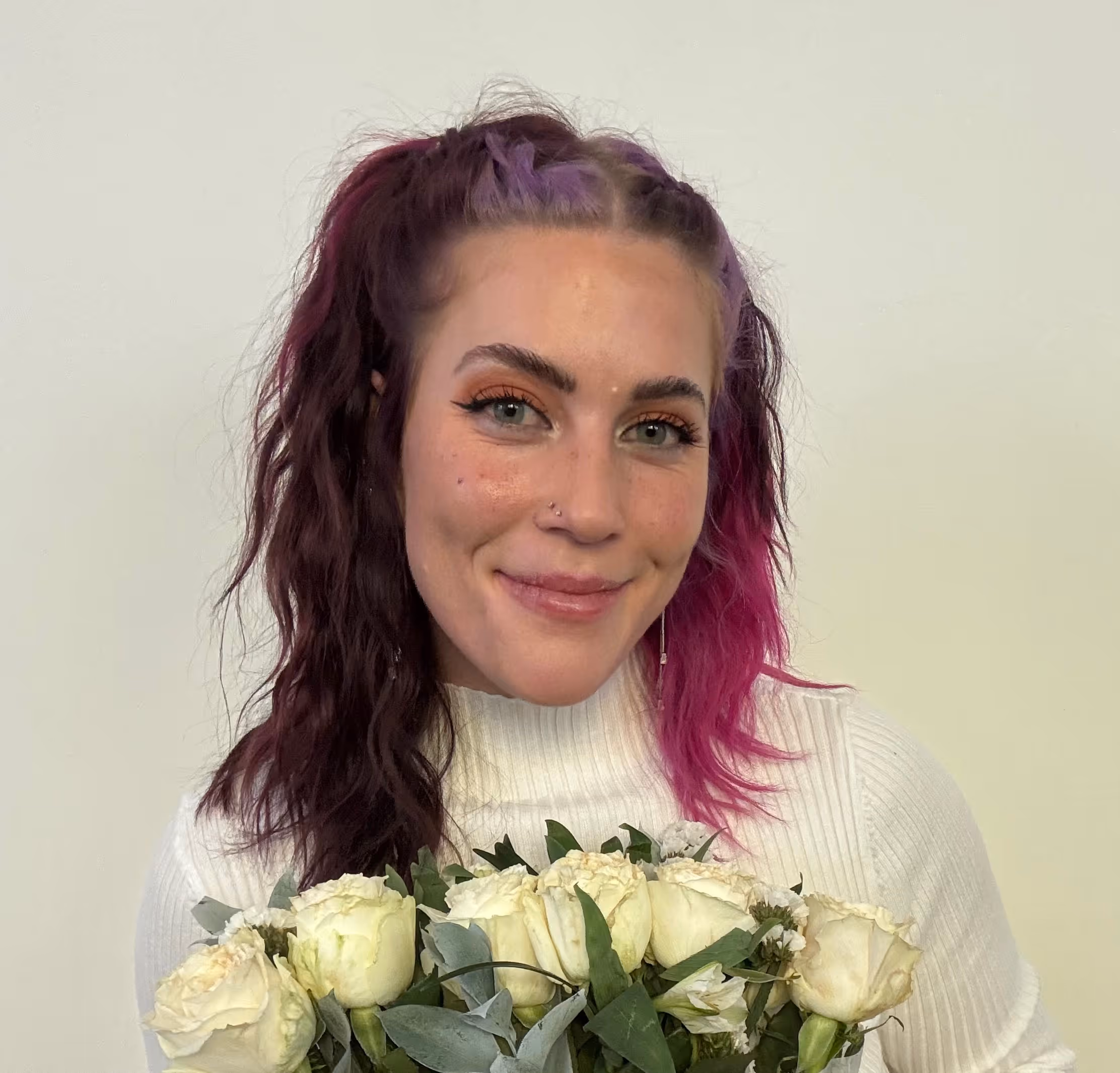 headshot of a girl holding flowers