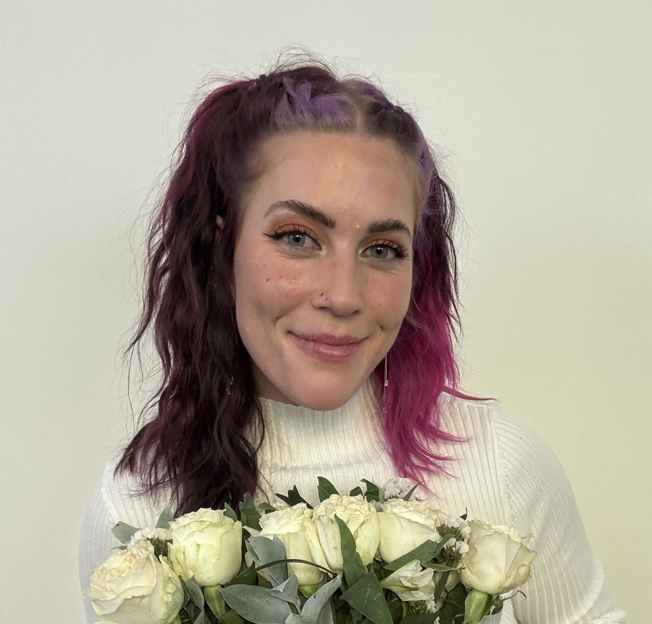 headshot of a girl holding flowers